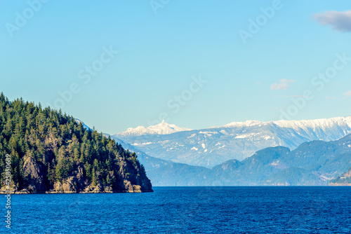 Fantastic view over ocean, snow mountain and rocks at Sechelt inlet in Vancouver, Canada.