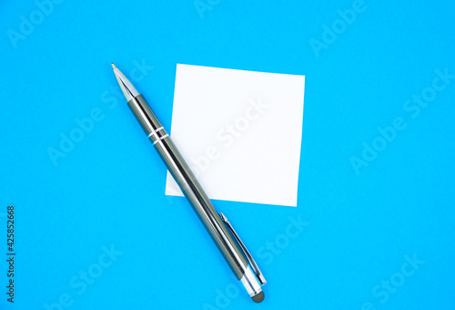 Blank white To Do List Sticker with pen. Searching information on the Internet..Close up of reminder note paper on the blue background. Copy space. Minimalism, original and creative.