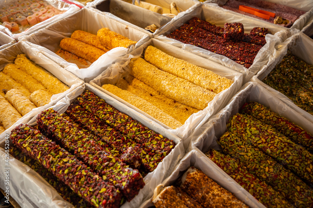 Sweet rolls made of nougat and nuts for sale in turkish market in Antalya, Turkey Sweet rolls made of nougat and nuts for sale in turkish market in Antalya, Turkey