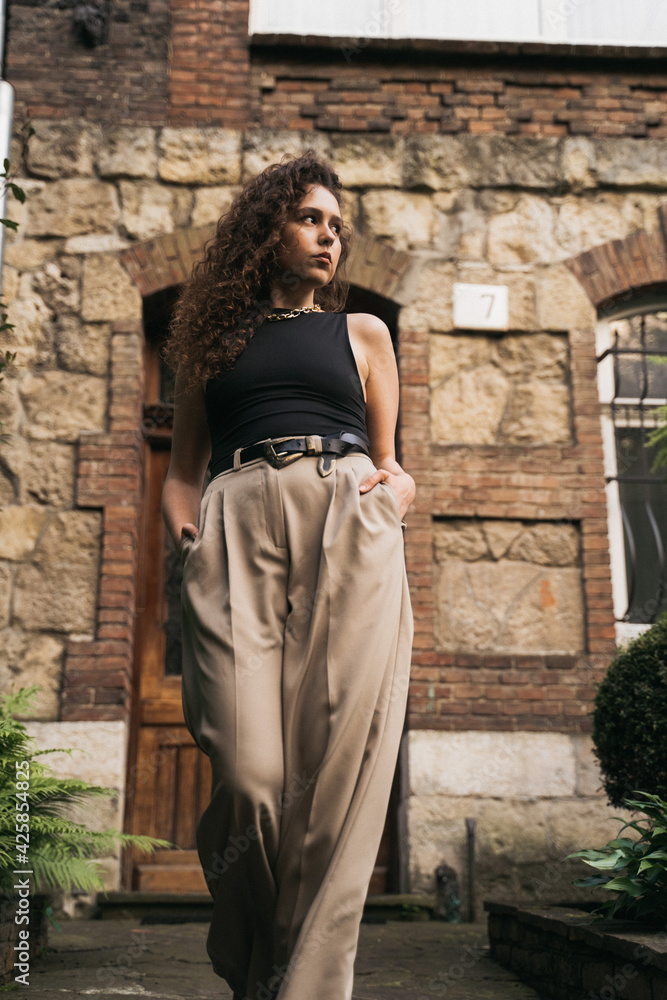 Curly girl walking down street