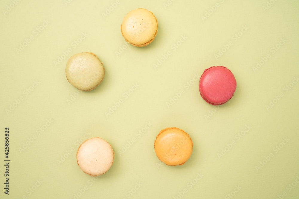 Colorful French macaroons on green background with copy space Colorful French macaroons on green background with copy space
