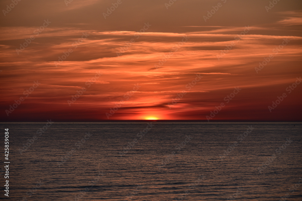 sunset at sea with a calm water surface
