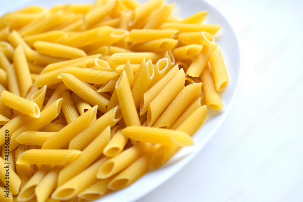 Yellow delicious pasta close-up on a white plate Yellow delicious pasta close-up on a white plate