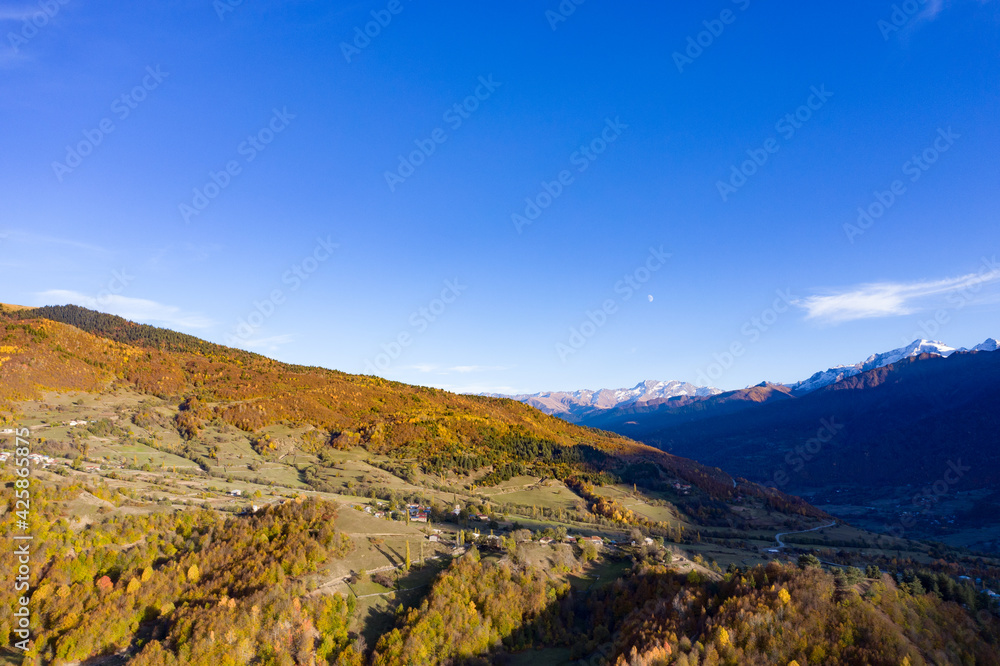 Top view of the autumn forest mountains at sunset