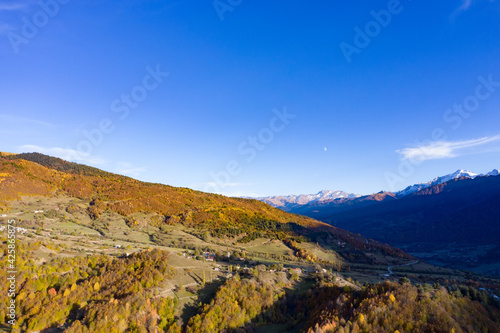 Top view of the autumn forest mountains at sunset