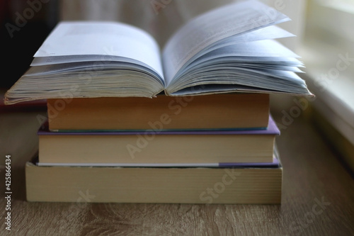 Stack of books on a table. Selective focus.