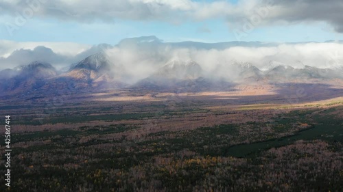 Eastern Sayans in autumn. Tunkinsky Goltsy ridge. Low cloud cover. photo