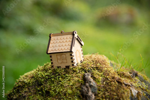 Wooden house model in a forest Eco house concept