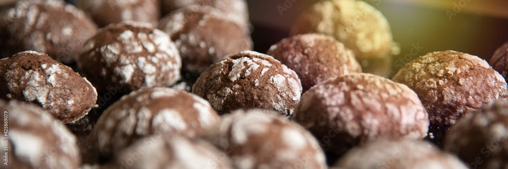 Cracked chocolate cookies with icing sugar on a pan Cracked chocolate cookies with icing sugar on a pan
