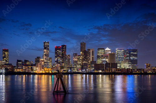 Night view to the illuminated skyline of the financial district Canary Wharf in London  United Kingdom