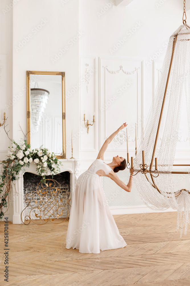 Elegant dancer in light studio dances Elegant dancer in light studio dances
