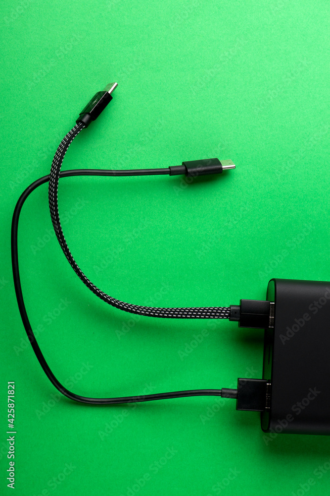Black Power Bank with adapter for charging mobile devices. Power Bank close-up. Black Power Bank with adapter for charging mobile devices. Power Bank close-up.