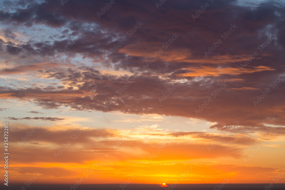 golden sunrise over the mediterranean sea and colorful clouds