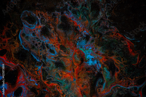 Texture in the style of fluid art. Abstract background with swirling paint effect. Liquid acrylic paint background. Black, blue and red colors.