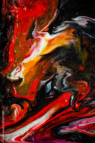 Texture in the style of fluid art. Abstract background with swirling paint effect. Liquid acrylic paint background. Black, yellow, white, lilac and red colors.