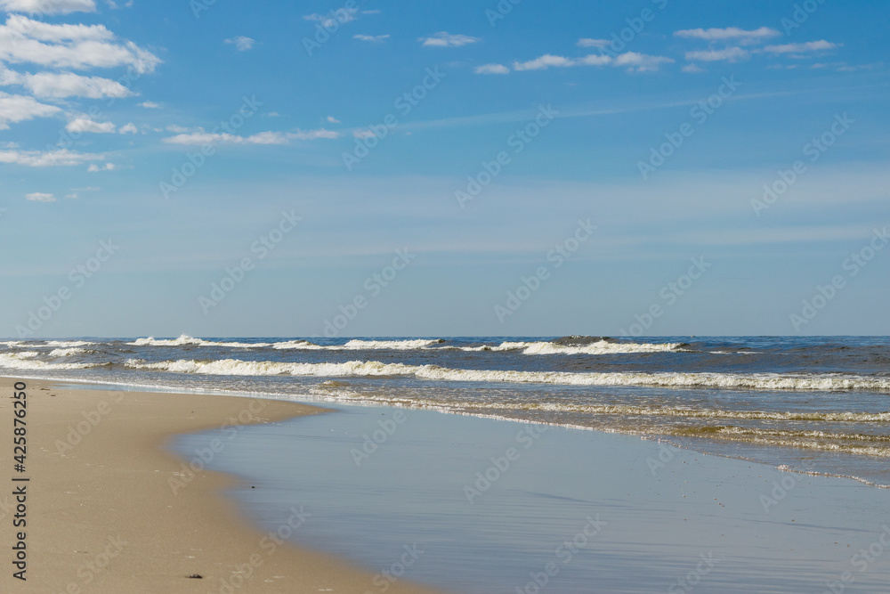 View of the sandy beach of the Baltic Sea on a windy day