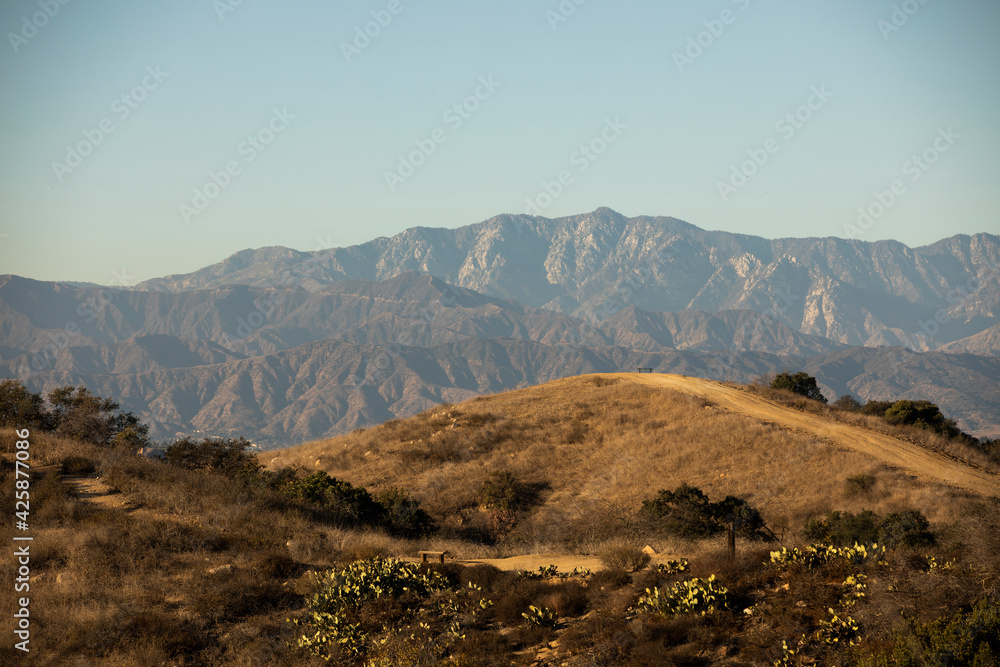 Day time view of the hills of Diamond Bar, California, USA stacked in front of the San Gabriel Mountains.