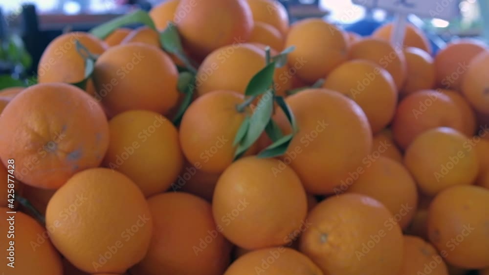 Pile of ripe oranges at farmers fruit and vegetable market Pile of ripe oranges at farmers fruit and vegetable market