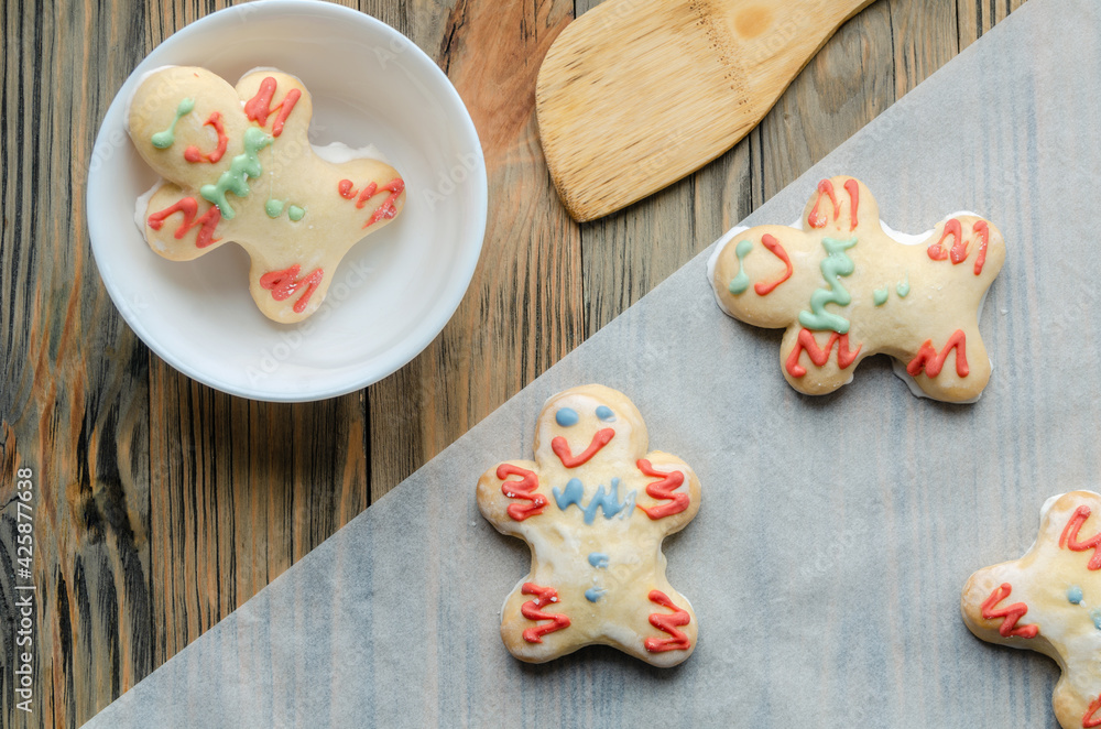 gingerbread gingerbread men on a wooden table. gingerbread gingerbread men on a wooden table.