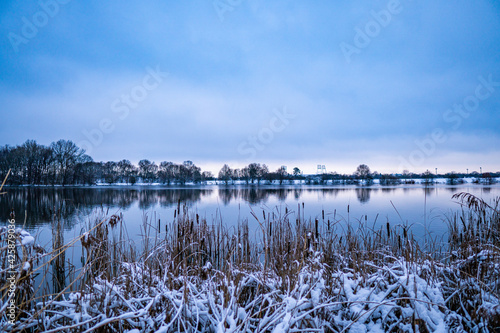 beautiful  almost frozen river called werdersee at cold snowy white winter in bremen