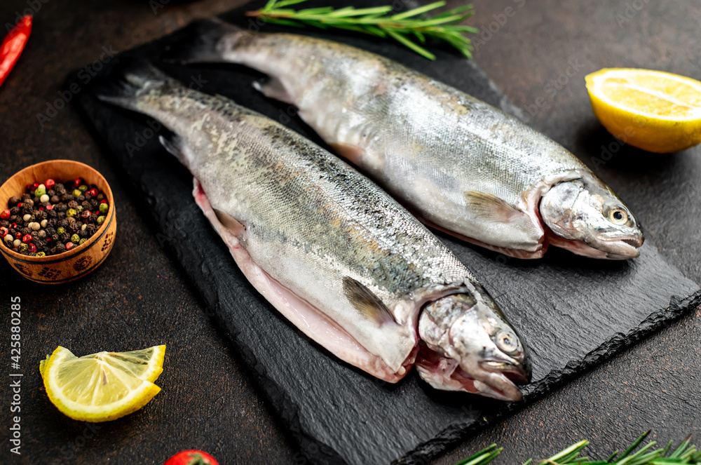 raw fish trout on a stone background. raw fish trout on a stone background.
