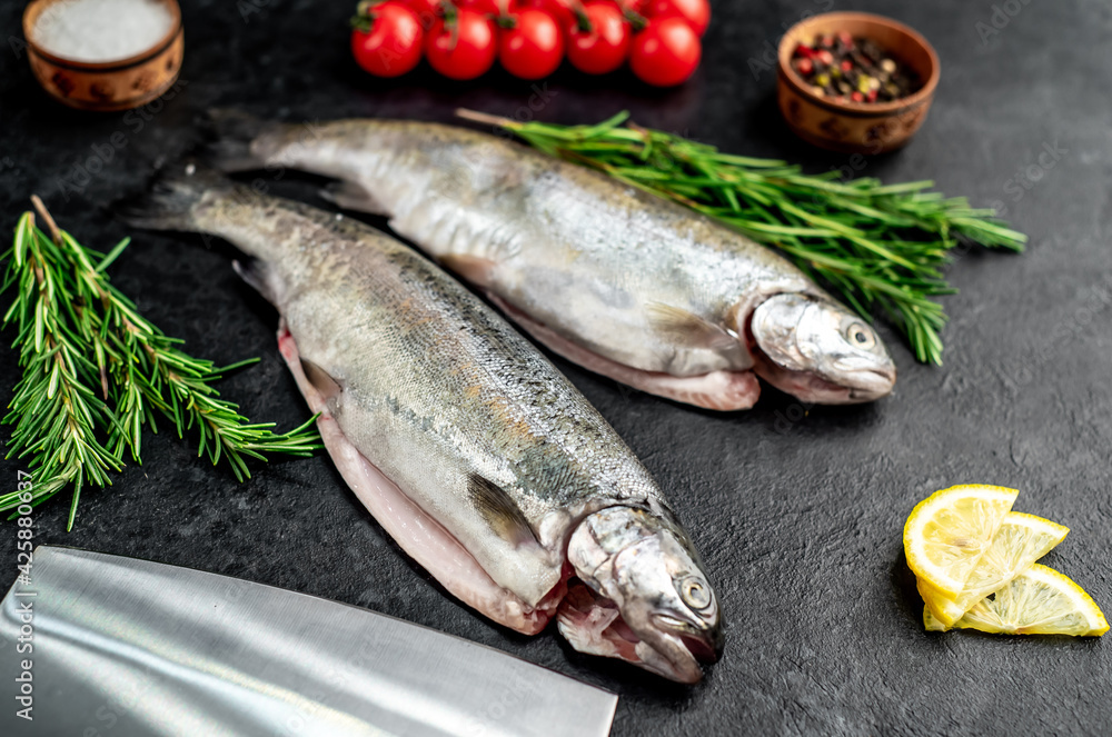 raw fish trout on a stone background. raw fish trout on a stone background.
