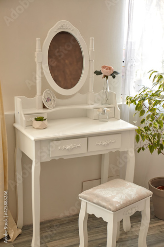Fotografía portrait of vintage vanity table set with stool and mirror