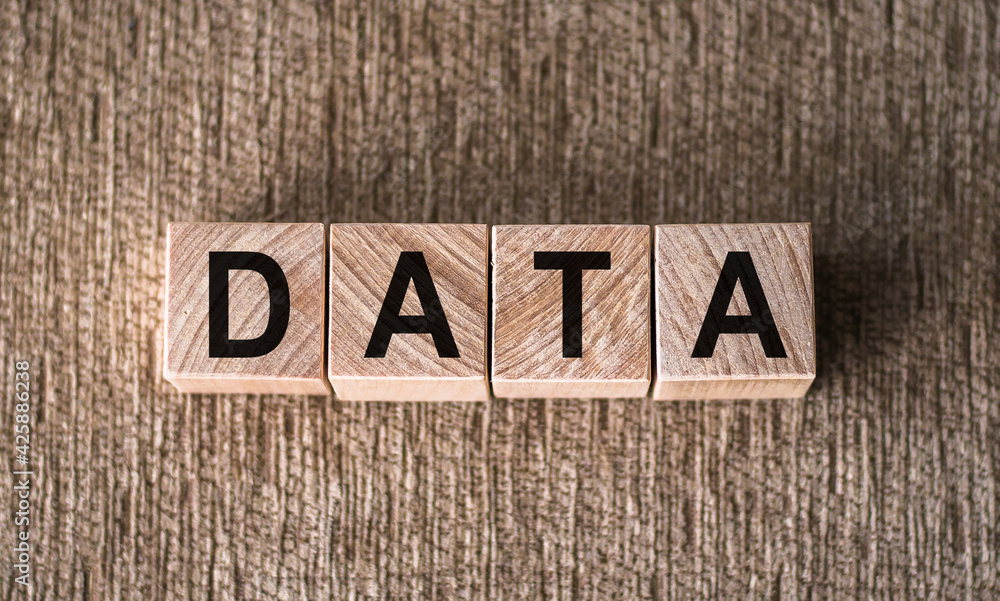 Fototapeta premium DATA word written on wooden blocks on a brown background.