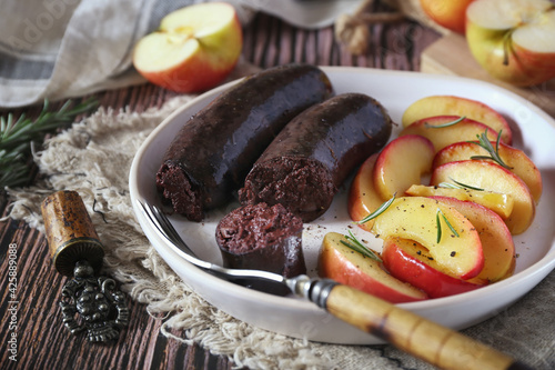 Fried blood sausage and apples photo