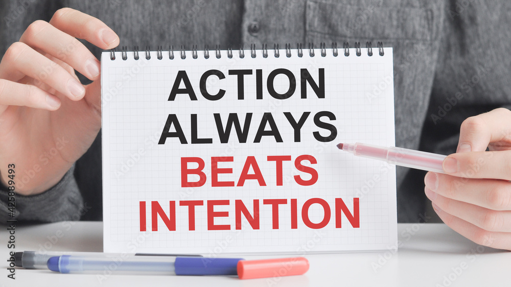 a card in the hands of a man with the inscription action always beats intention a card in the hands of a man with the inscription action always beats intention