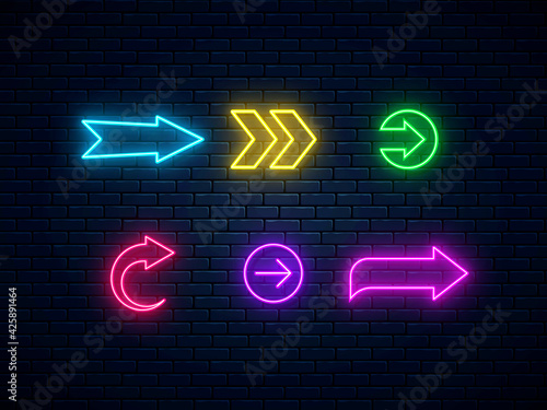 Neon arrow signs collection. Bright arrow pointer symbols on brick wall background. Set of colorful neon arrows, web icons. Banner design, bright advertising signboard elements. Vector illustration.