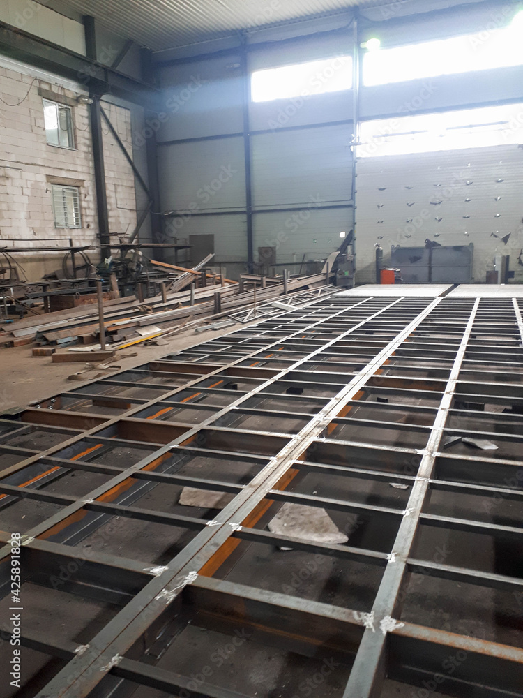 Metal beams and heavy steel piles as part of strengthening and supporting the roof of a building