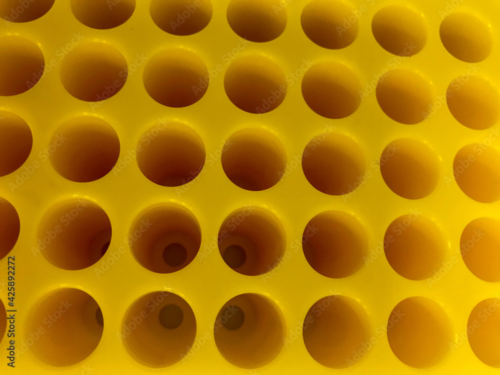 medical devices for performing analyzes. equipment for a blood collection point. bright yellow plastic container for test tubes. container for test tubes with blood medical devices for performing analyzes. equipment for a blood collection point. bright yellow plastic container for test tubes. container for test tubes with blood
