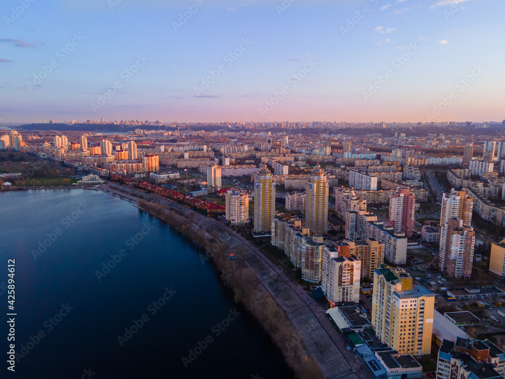 Aerial view from a drone to the sunset over the city of Kiev on Obolon embankment