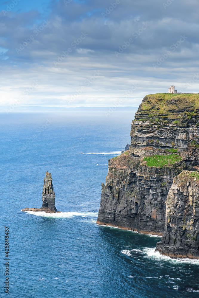 View on Cliff of Moher, county Clare, Ireland. Epic landscape with magnificent scenery. Irish landmark and popular tourist attraction. Atlantic ocean, Cloudy sky View on Cliff of Moher, county Clare, Ireland. Epic landscape with magnificent scenery. Irish landmark and popular tourist attraction. Atlantic ocean, Cloudy sky