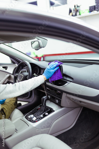 A man cleaning car interior, car detailing (or valeting) concept. Selective focus. © hedgehog94
