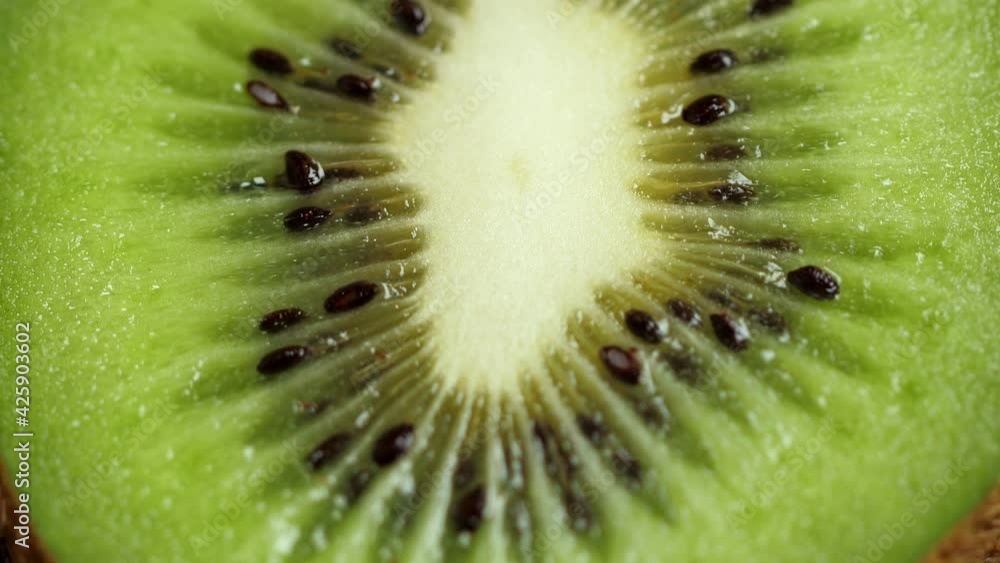 A lot of sliced Kiwi rotating. Ripe Tropical fruits. Macro shot A lot of sliced Kiwi rotating. Ripe Tropical fruits. Macro shot