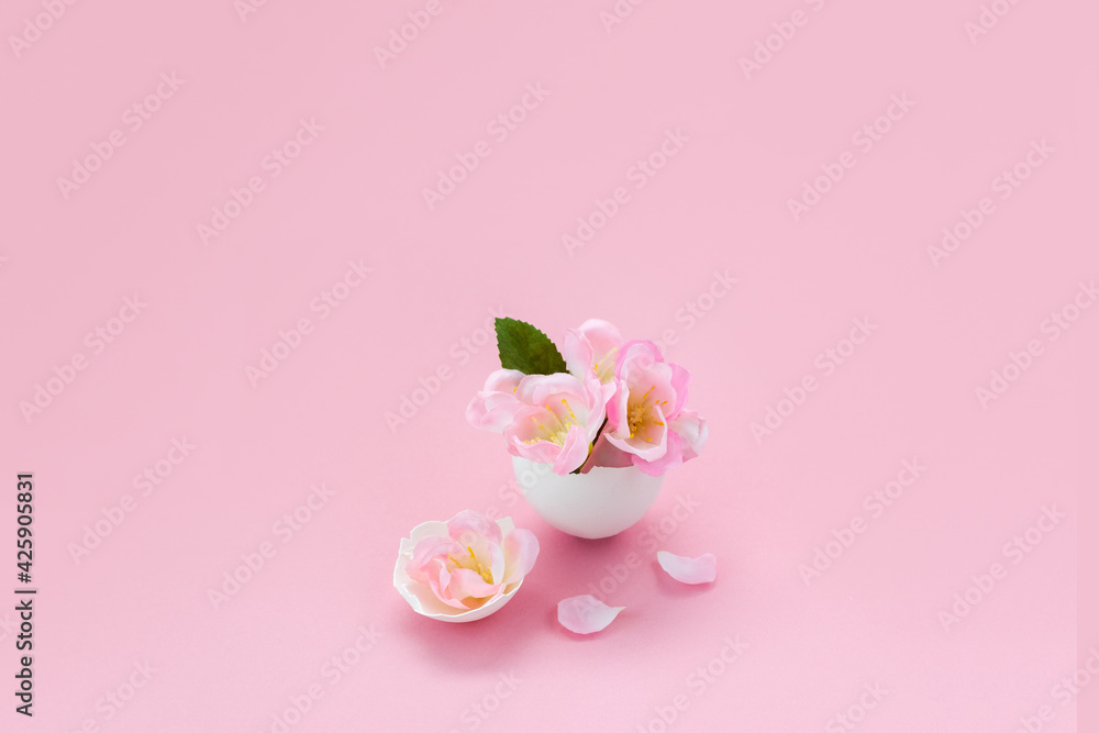 Spring sakura flowers in egg shell. Minimal creative Easter concept. Selective focus, place for text.