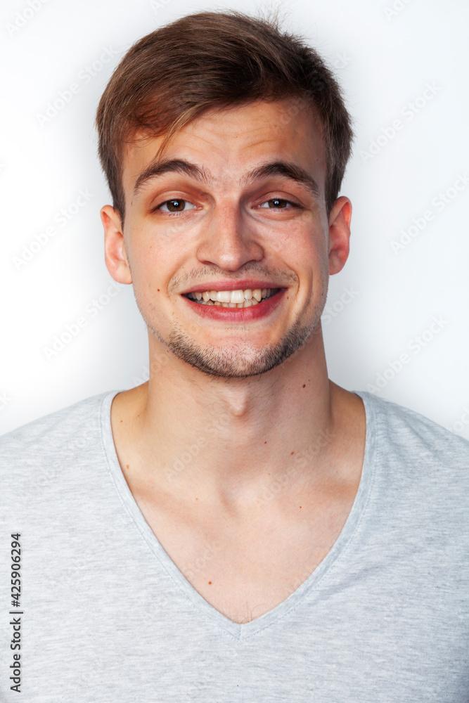 Obraz premium young handsome teenage hipster guy posing emotional, happy smiling against white background isolated, lifestyle people concept
