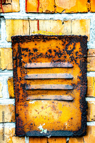 Old metal, rusty ventilation cover.
