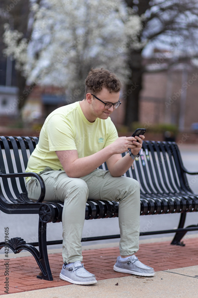 Young man texting while downtown