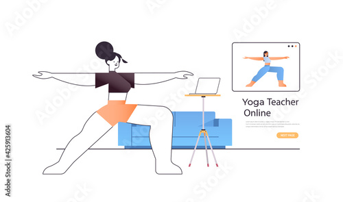 woman doing stretching exercises while watching online video training program with yoga teacher workout