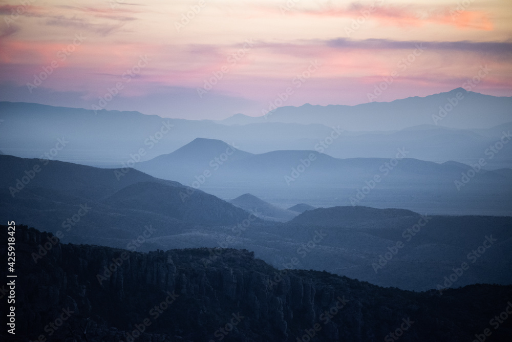 the sun setting over endless mountain layers in Arizona the sun setting over endless mountain layers in Arizona