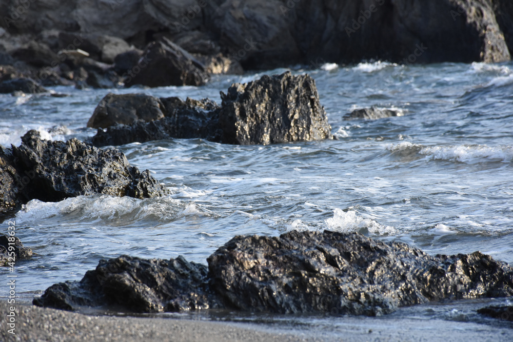 waves crashing on rocks in beach waves crashing on rocks in beach