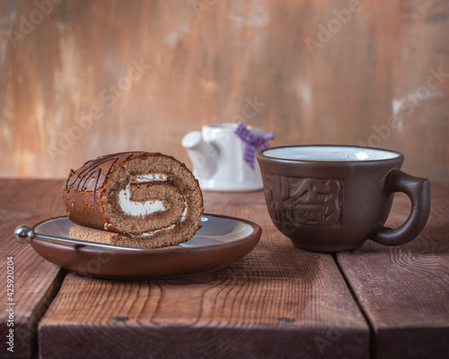 Sweet lunch with stuffed roll and zeo tea in a clay mug photo