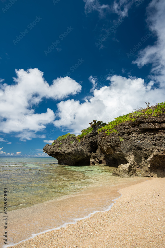 Beautiful little hidden beach with clear water, blue sky, nice clouds and rock formation typical of Okinawa in Unarizaki park. Iriomote Island. Beautiful little hidden beach with clear water, blue sky, nice clouds and rock formation typical of Okinawa in Unarizaki park. Iriomote Island.