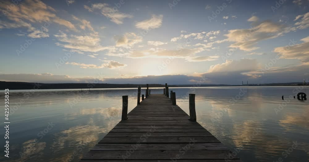 Lake and wooden old pier or jetty. Dramatic sunset clouds, 4k video Lake and wooden old pier or jetty. Dramatic sunset clouds, 4k video