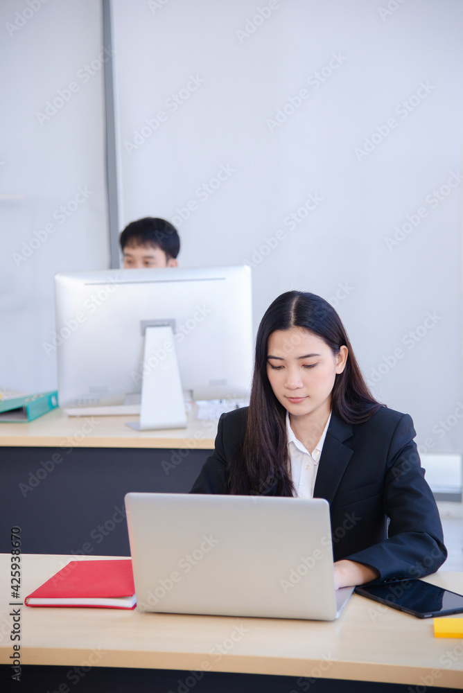 asian lady in business look working on her desk asian lady in business look working on her desk