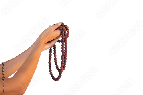 ็Hand woman holding rosary isolated on white background. female christian catholic religious faith praying. religion Ramadan.