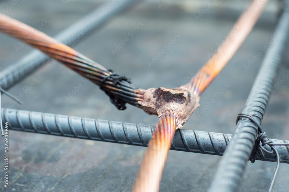 Welding copper ground wire on ground rod.Welding copper ground wire